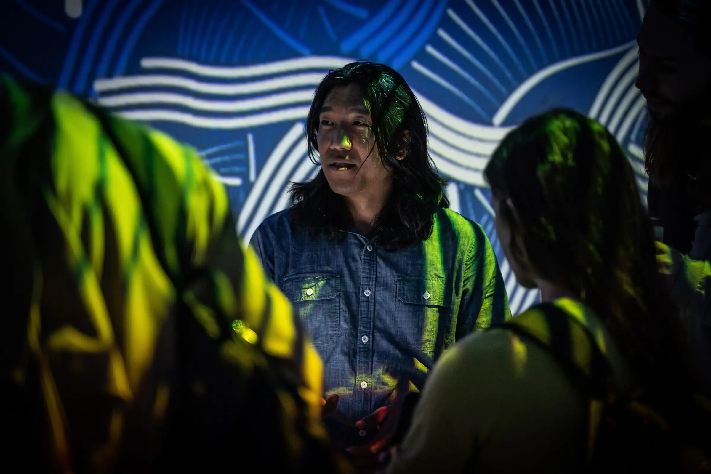 Visitors talking in front of INTRICADA projections, Lume Studios, New York.