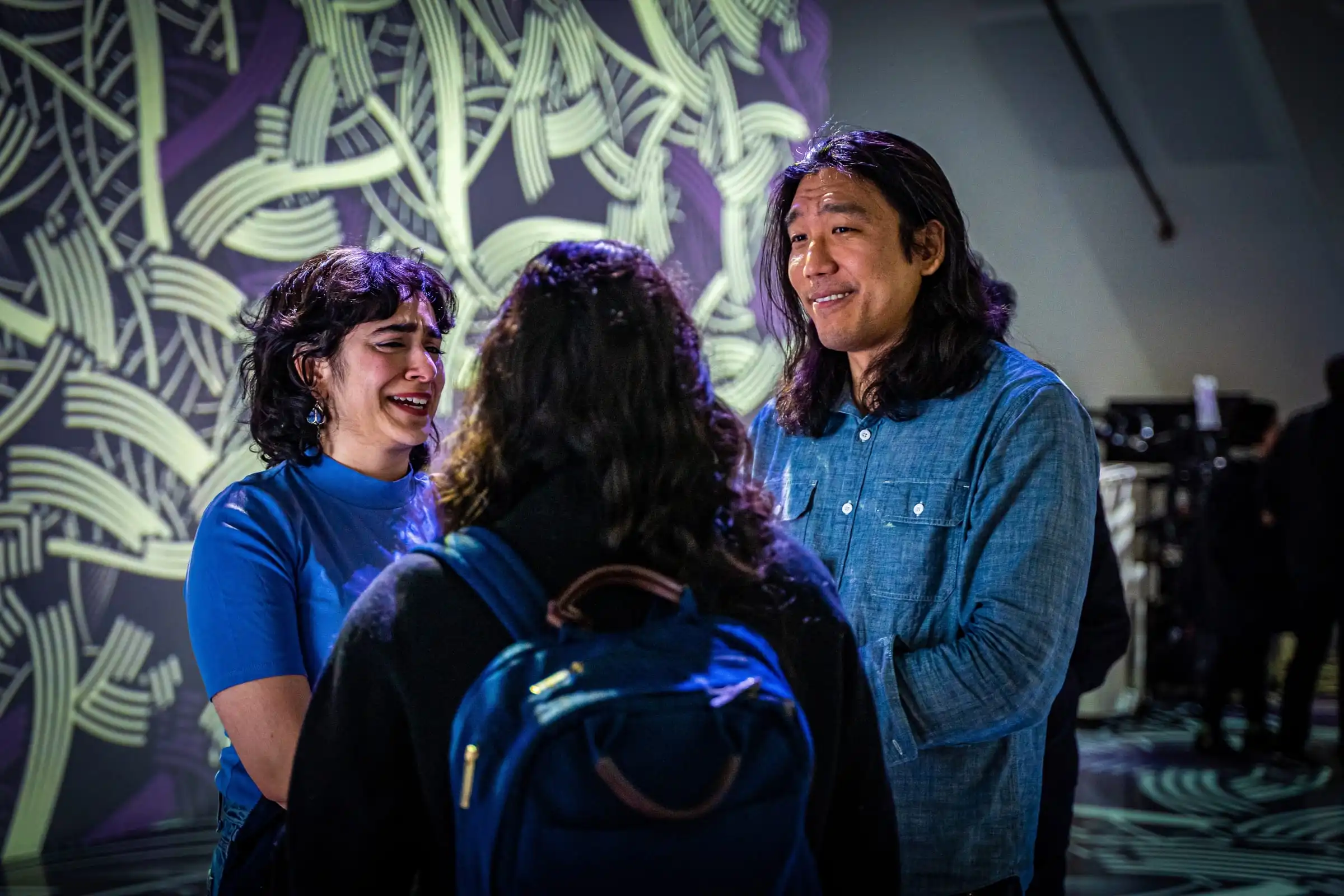 Visitors talking in front of INTRICADA projections, Lume Studios, New York.